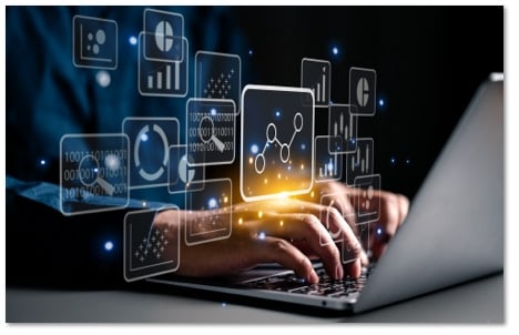 hands on a laptop with floating symbols on tiles in front of the screen