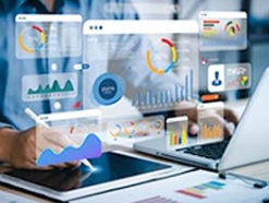 colorful charts and graphs floating in the air above an open laptop and tablet